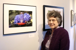 Village resident Jean Stringham and her photograph "Hummingbirds & Hydrangea"